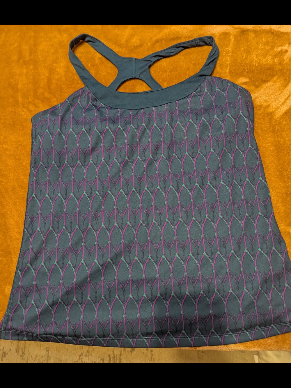 The North Face teal jacket with purple and green pattern